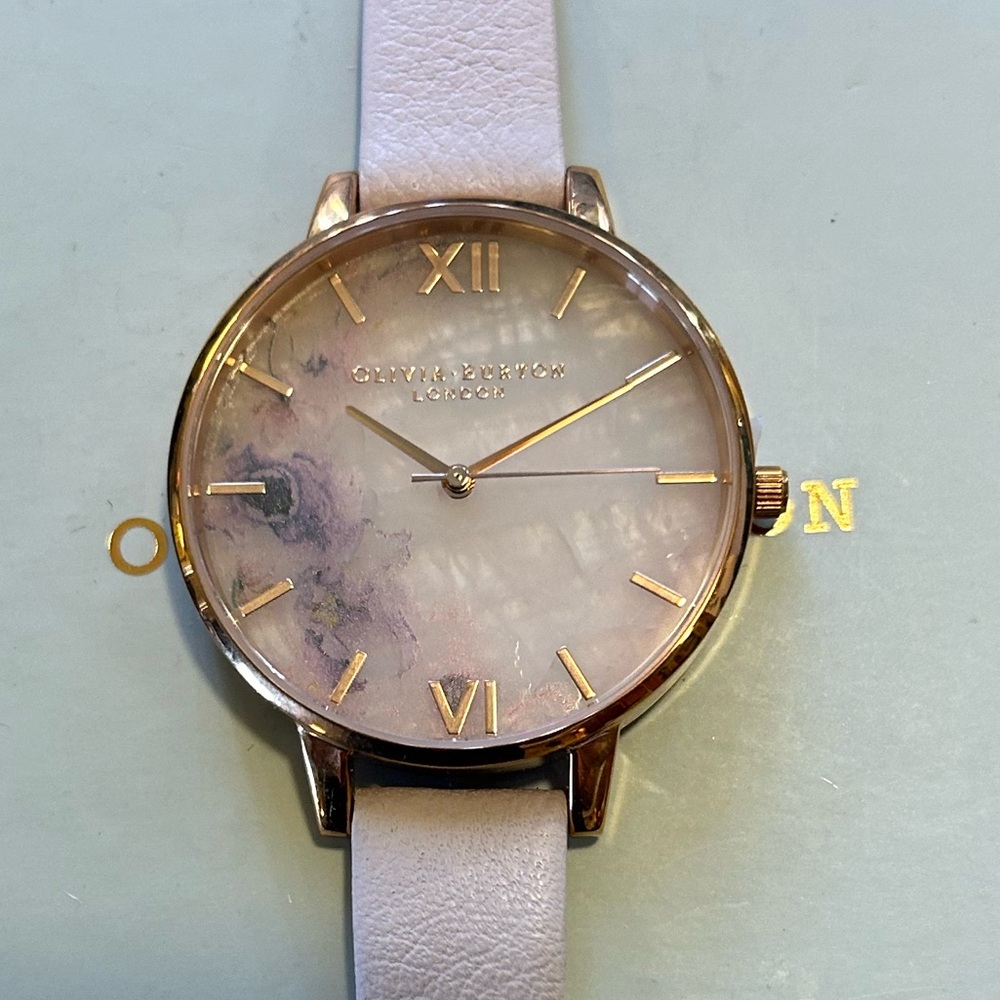 OLIVIA BURTON WATCH WITH 38MM SEMI PRECIOUS STONE FACE WITH FLORALS.
